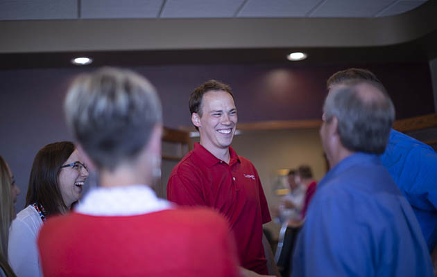 Key Accounts specialist Paul Mantz smiles and shakes hands.